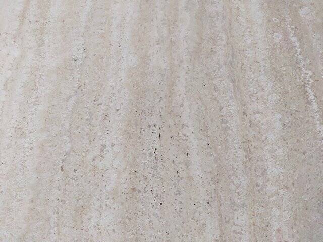 Octagonal dining table in travertine