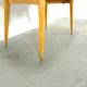 Vintage veneer table with pretty angular legs and brass at the base of the legs.