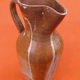 Glazed stoneware pitcher With white dripping on brown background Height: 270mm