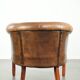 Sheepskin club armchair in a brown colour finished with decorative nails