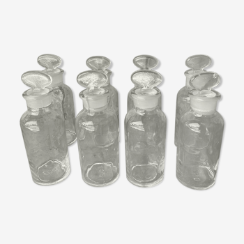 Old apothecary bottles in transparent glass.