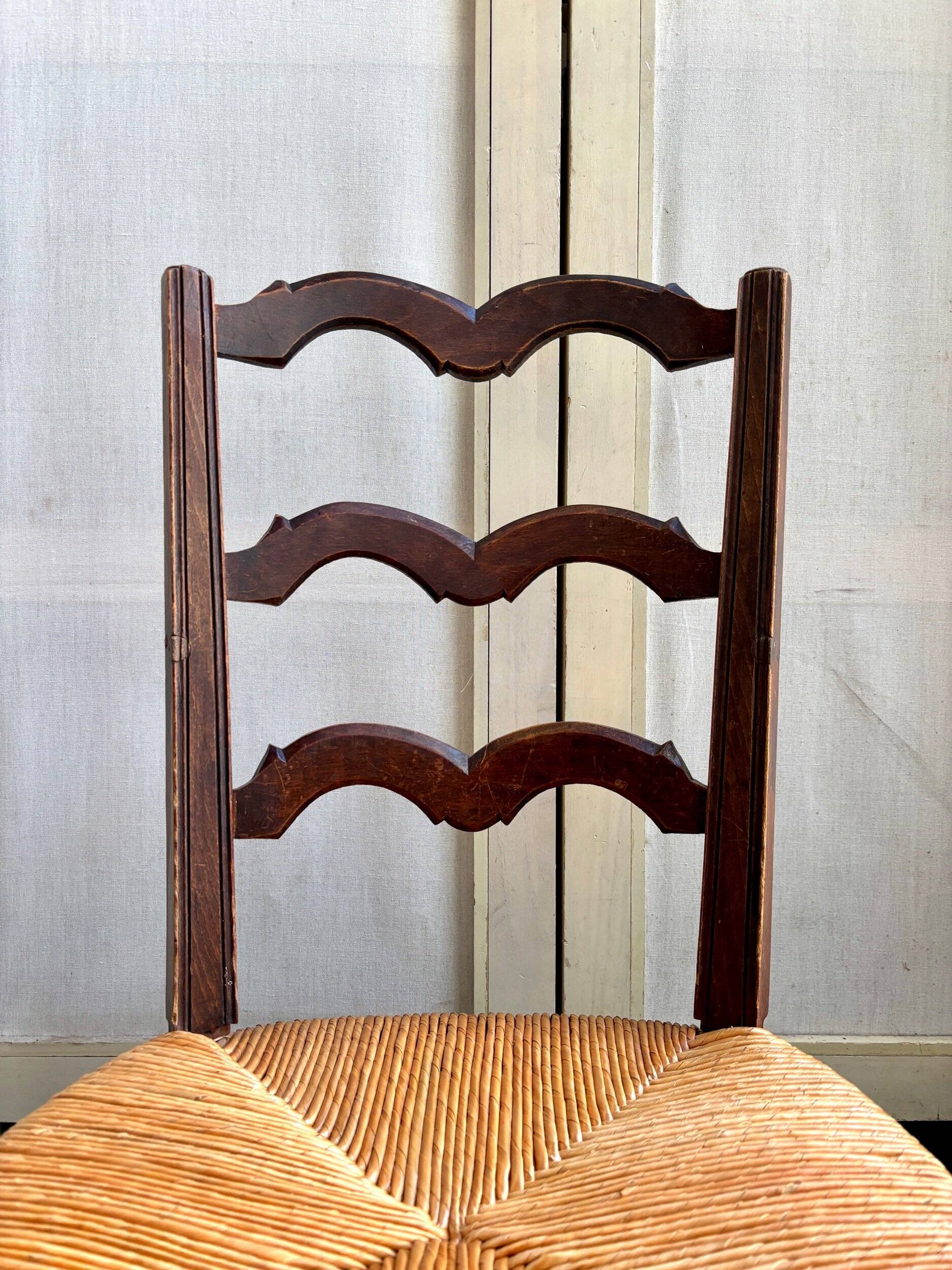 Low Provencal chair in dark wood and woven straw