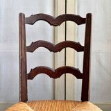 Low Provencal chair in dark wood and woven straw