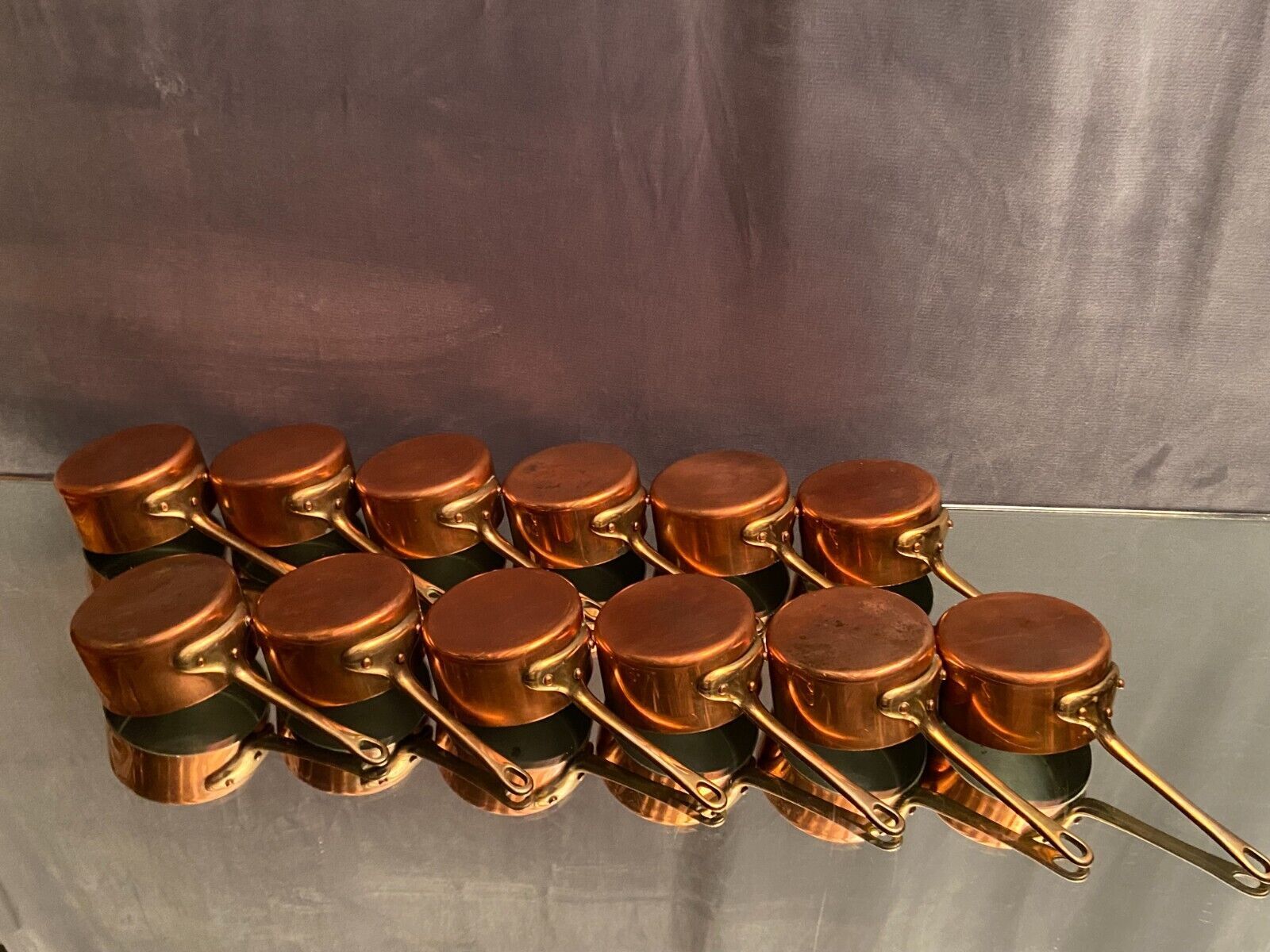 Suite of 12 tinned copper pans