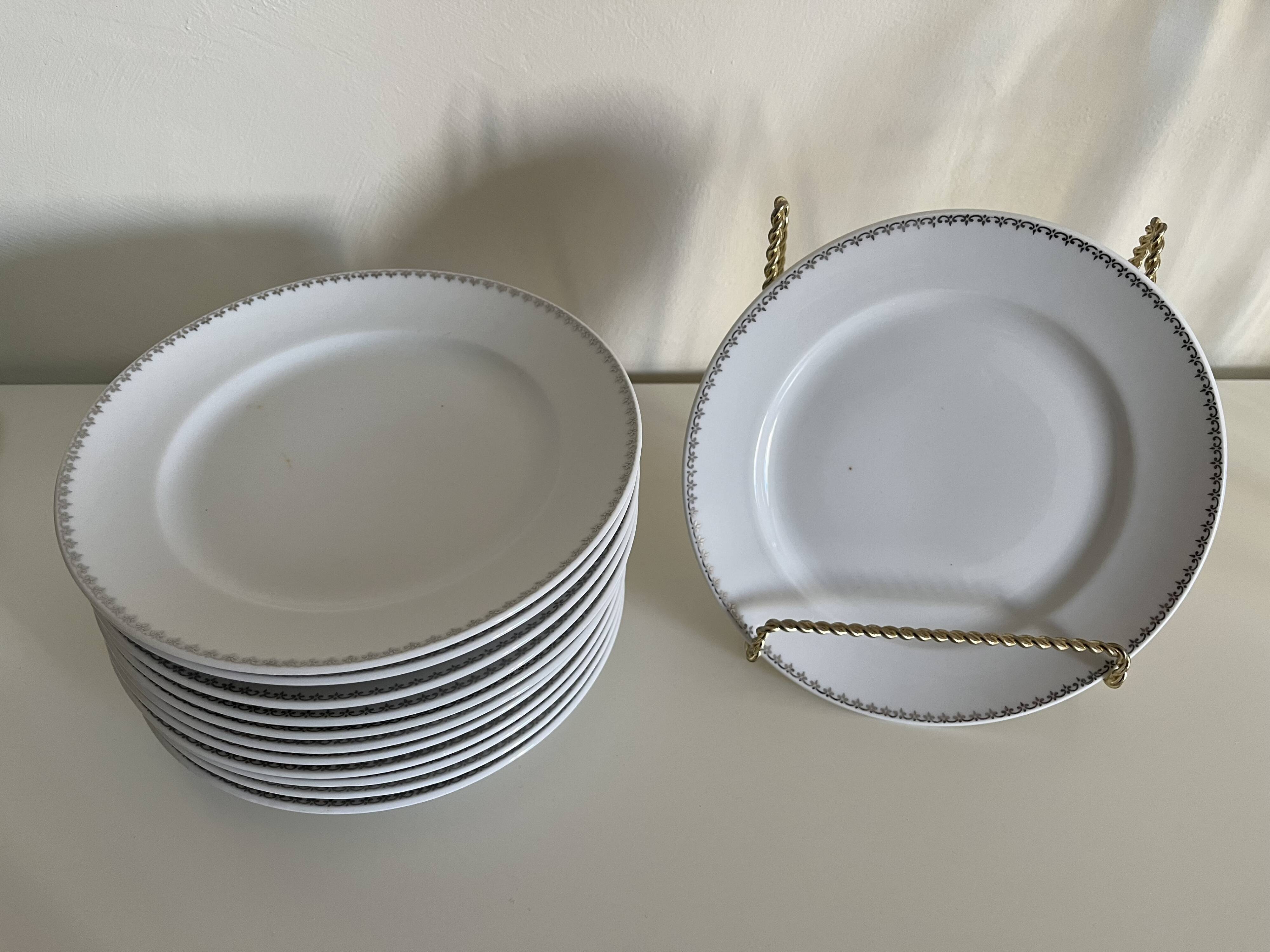 12 white porcelain plates with silver edging