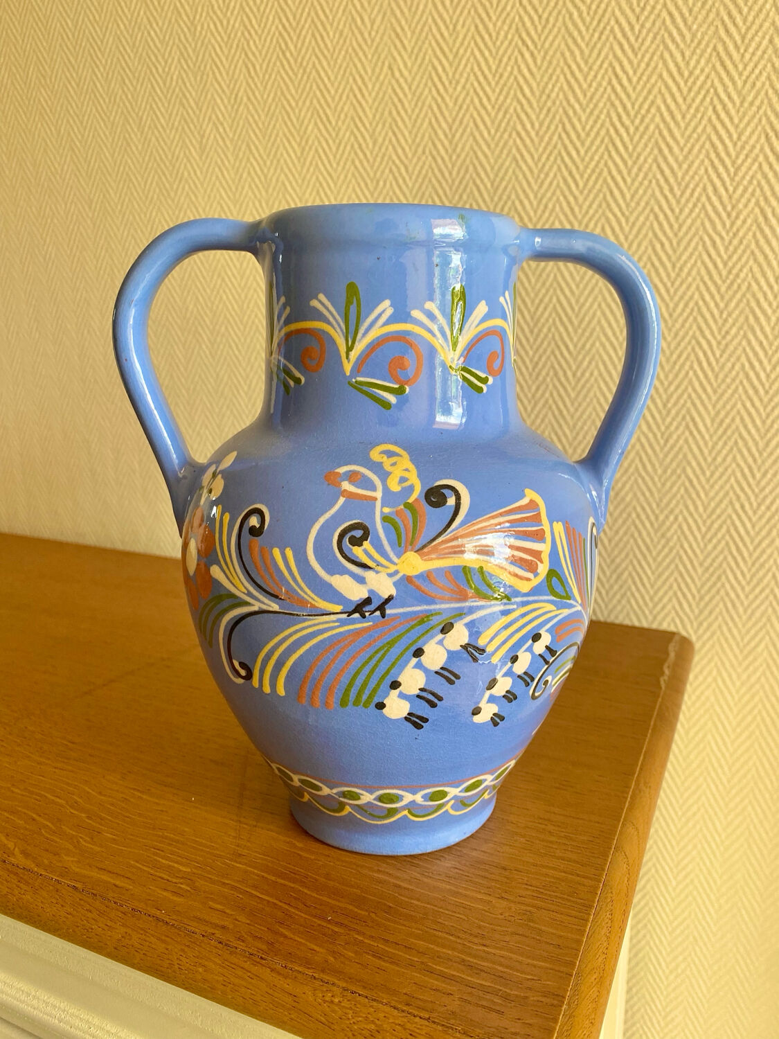 Glazed blue ceramic vase with folk decoration