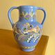 Glazed blue ceramic vase with folk decoration