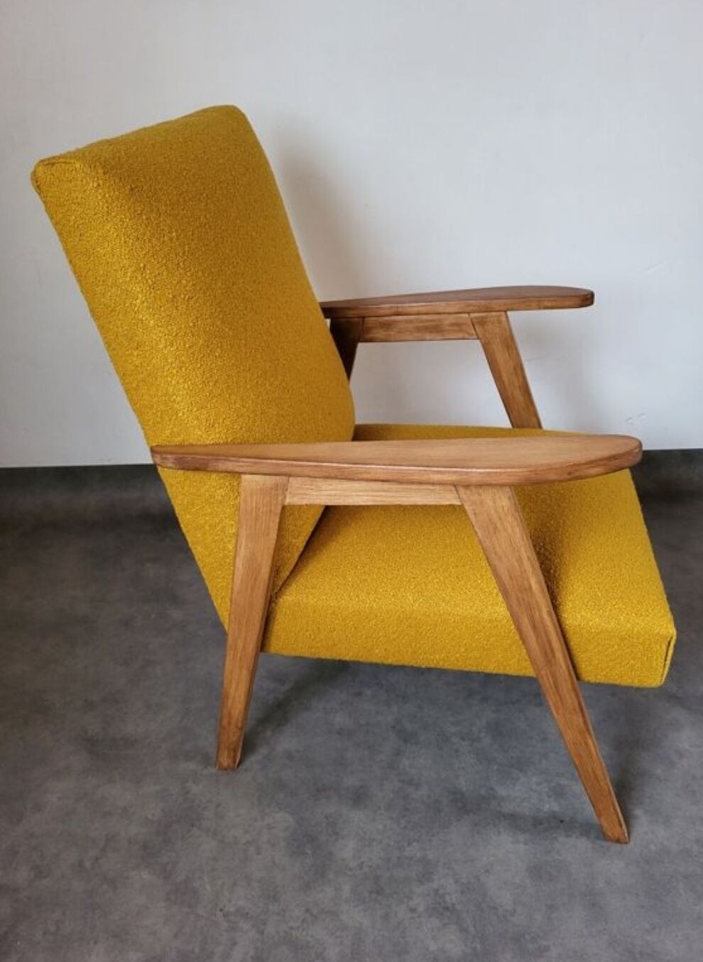Curly yellow Scandinavian armchair