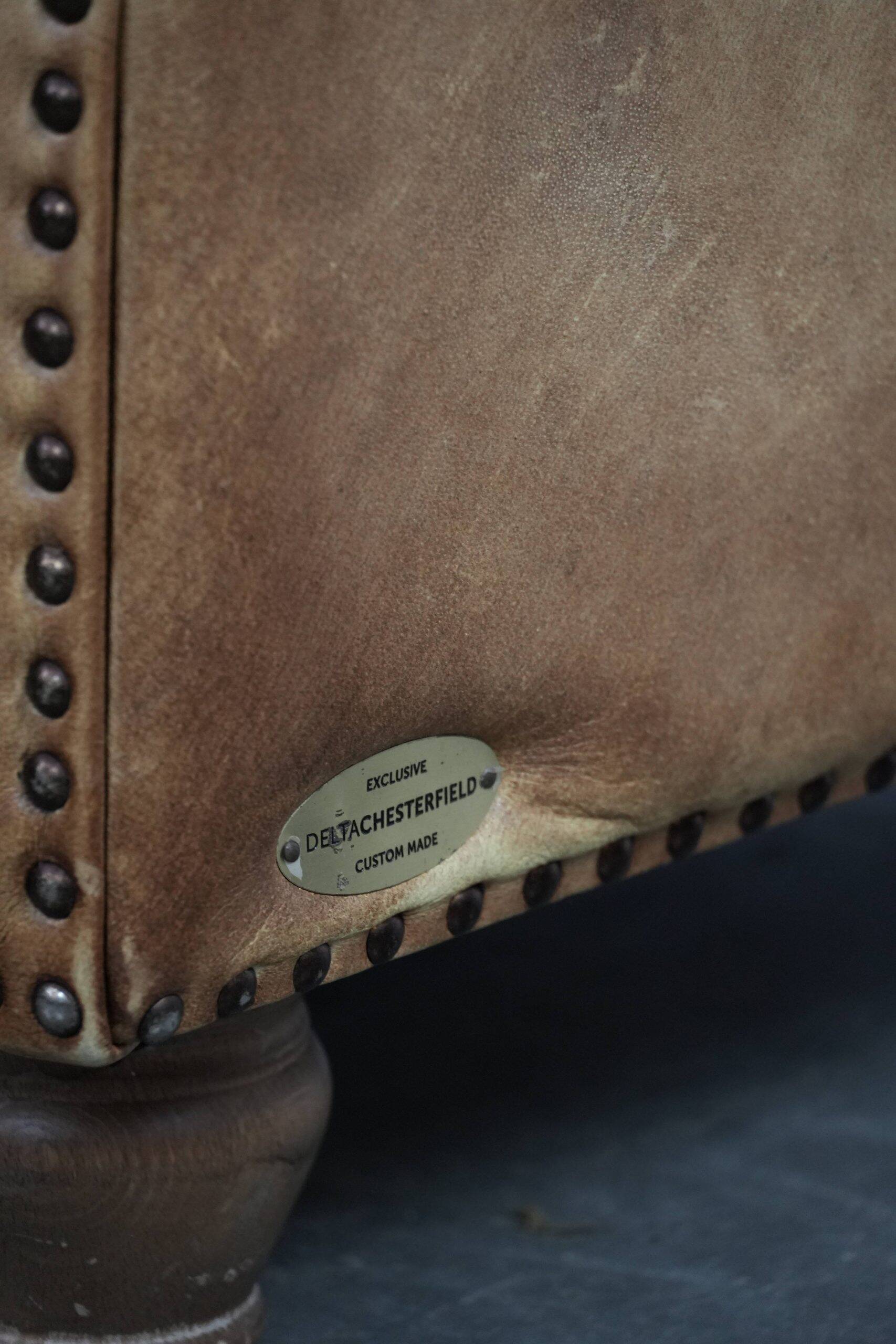 Chesterfield armchair made of cowhide leather in a light cognac colour