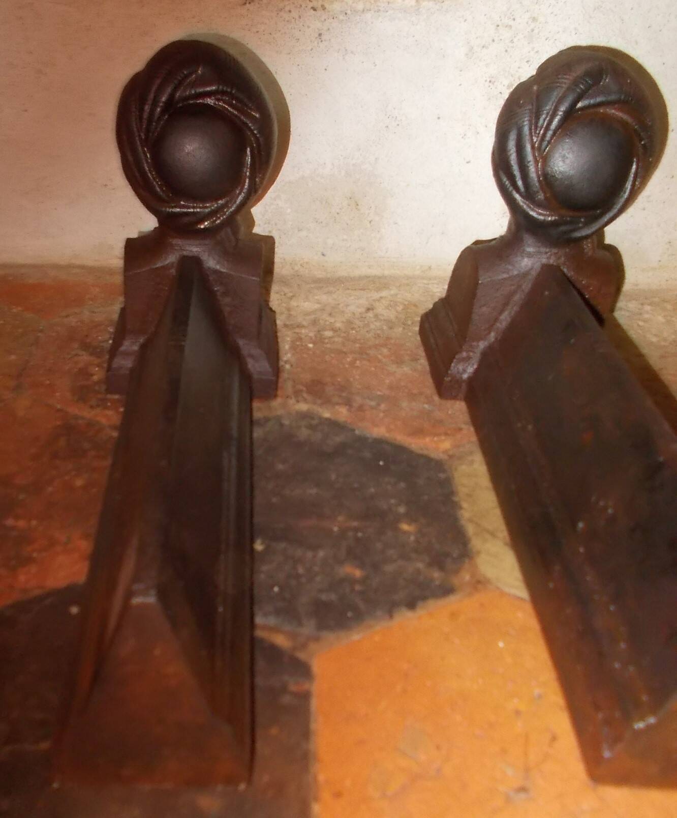 Old cast iron andirons with oriental decor