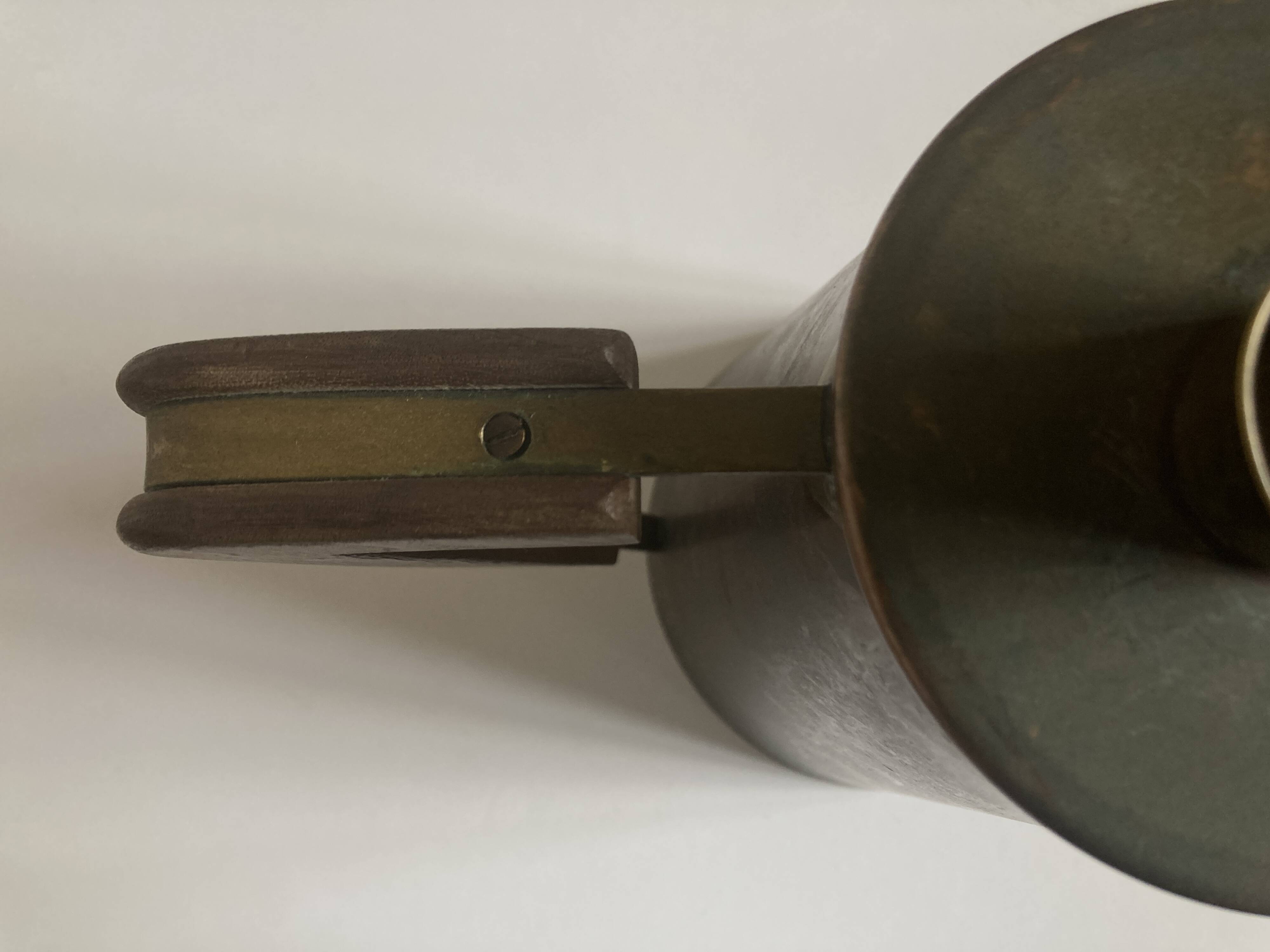 Modernist Italian pitcher design from the 1960s in patinated wood and metal.