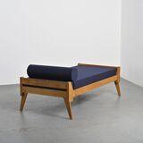 Wooden bench with midnight blue fabric, France, circa 1955