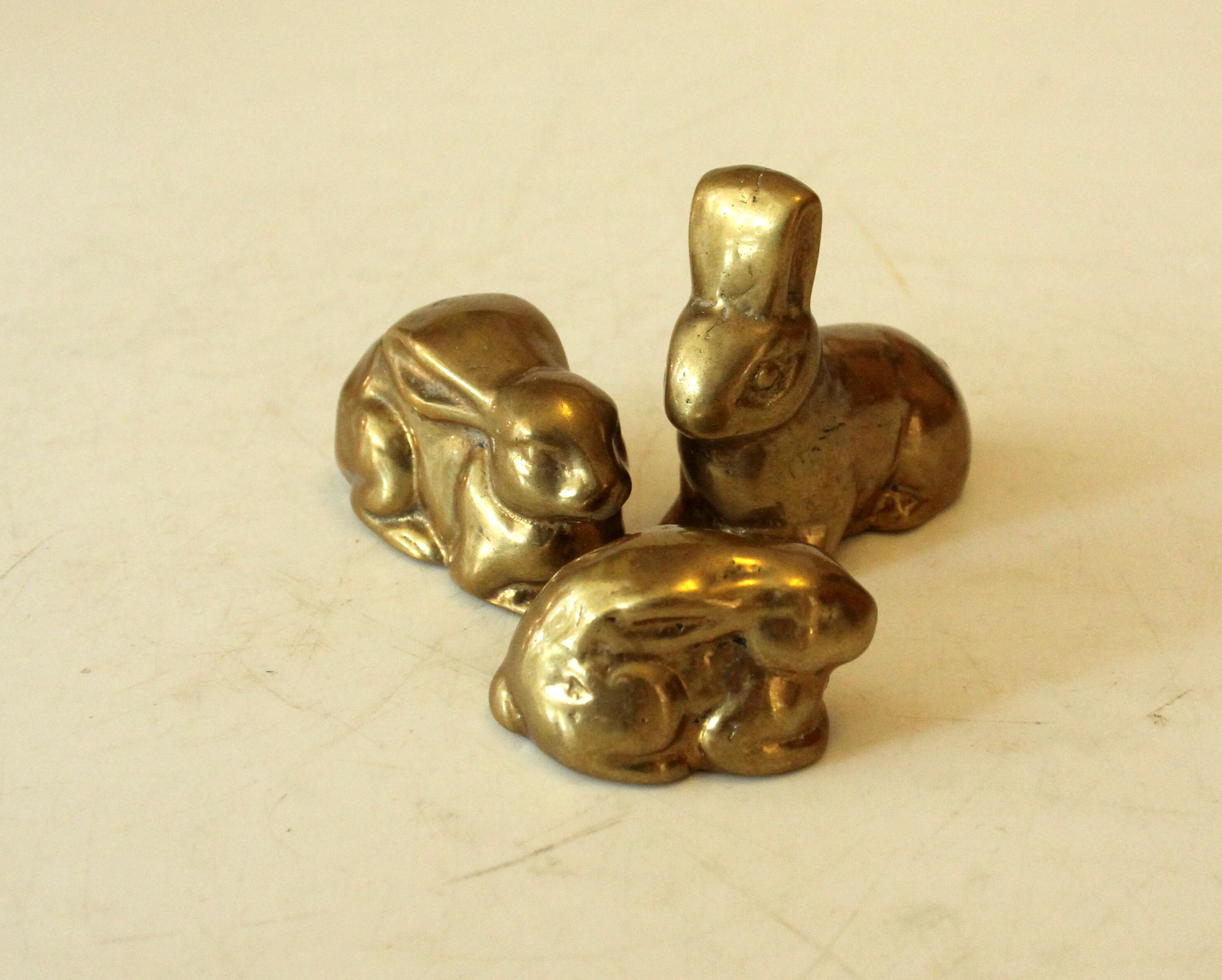 3 solid brass paperweights in the shape of rabbits vintage from the 1960s