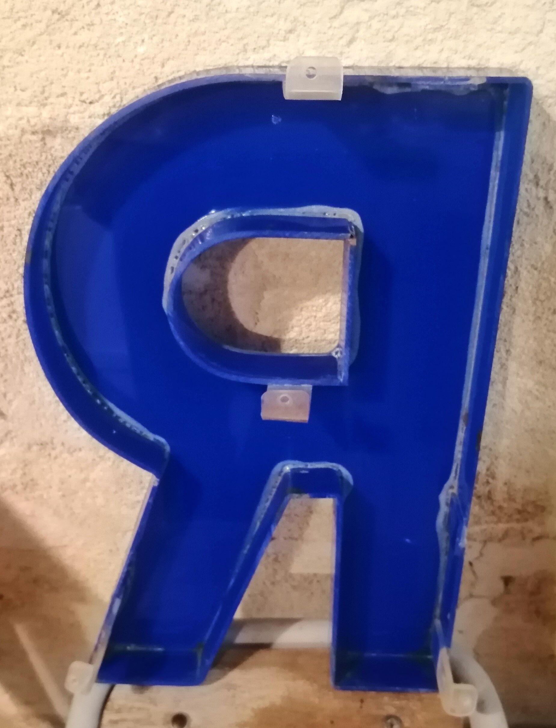 Letter R vintage sign in blue plexiglass