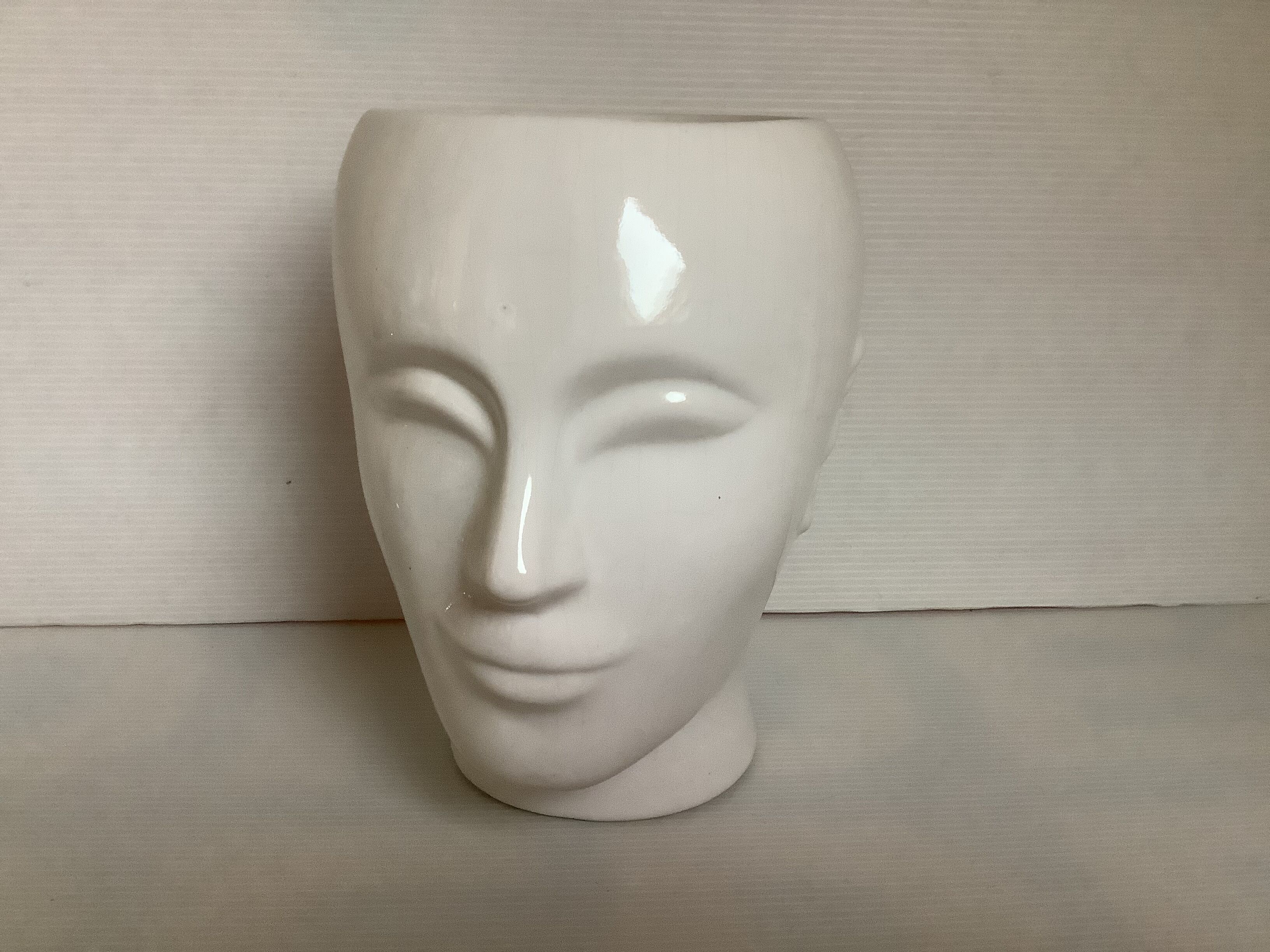 Man's head hide pot vase