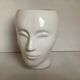 Man's head hide pot vase