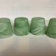 Four green glass paste candle holders