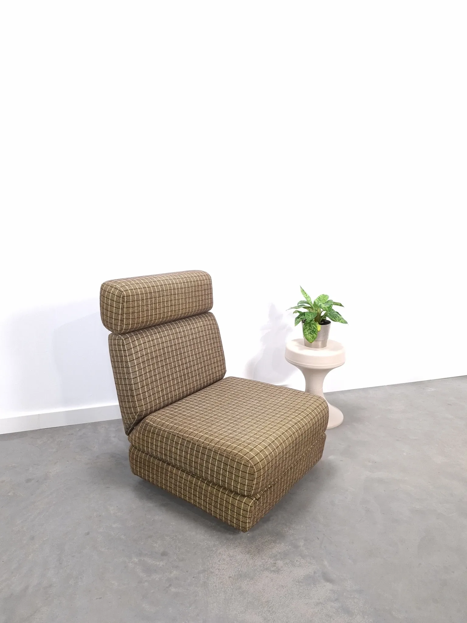 Vintage pull-out sofa bed, brown checked lounge chair with chrome.