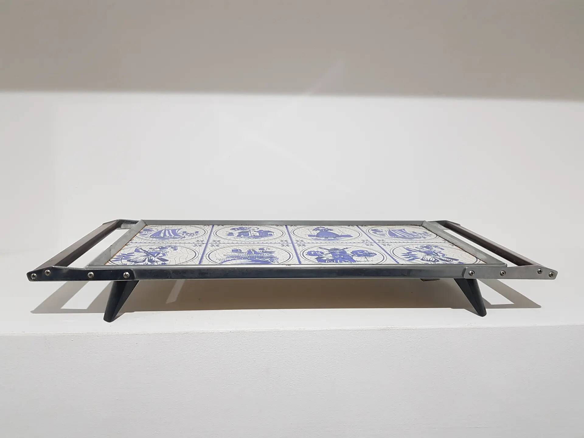 Heating plate, blue and white ceramic, brown rosewood, black metal, Germany, 1970s.