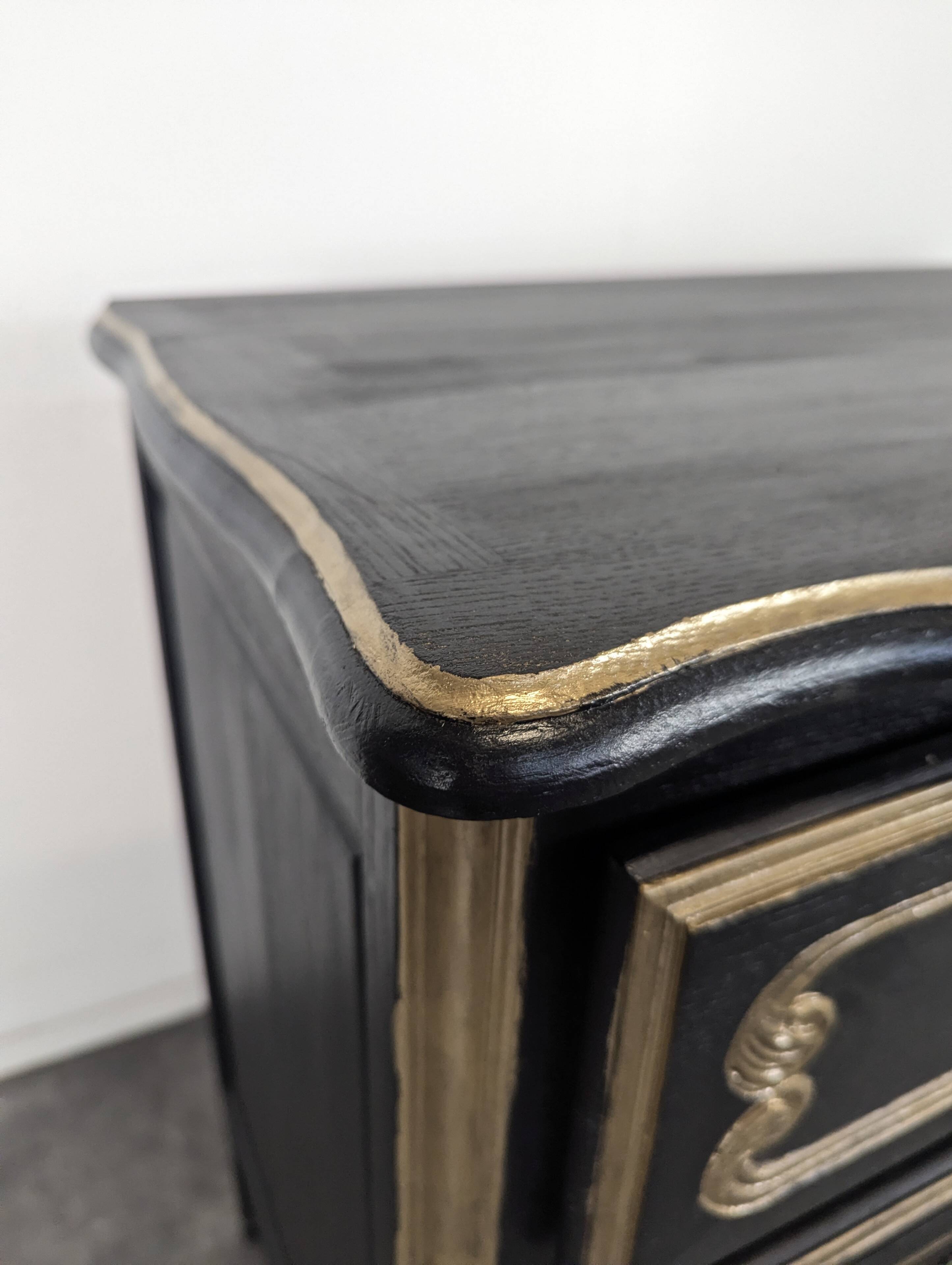 Commode de style Louis XV en chêne laqué noir et rechampi or