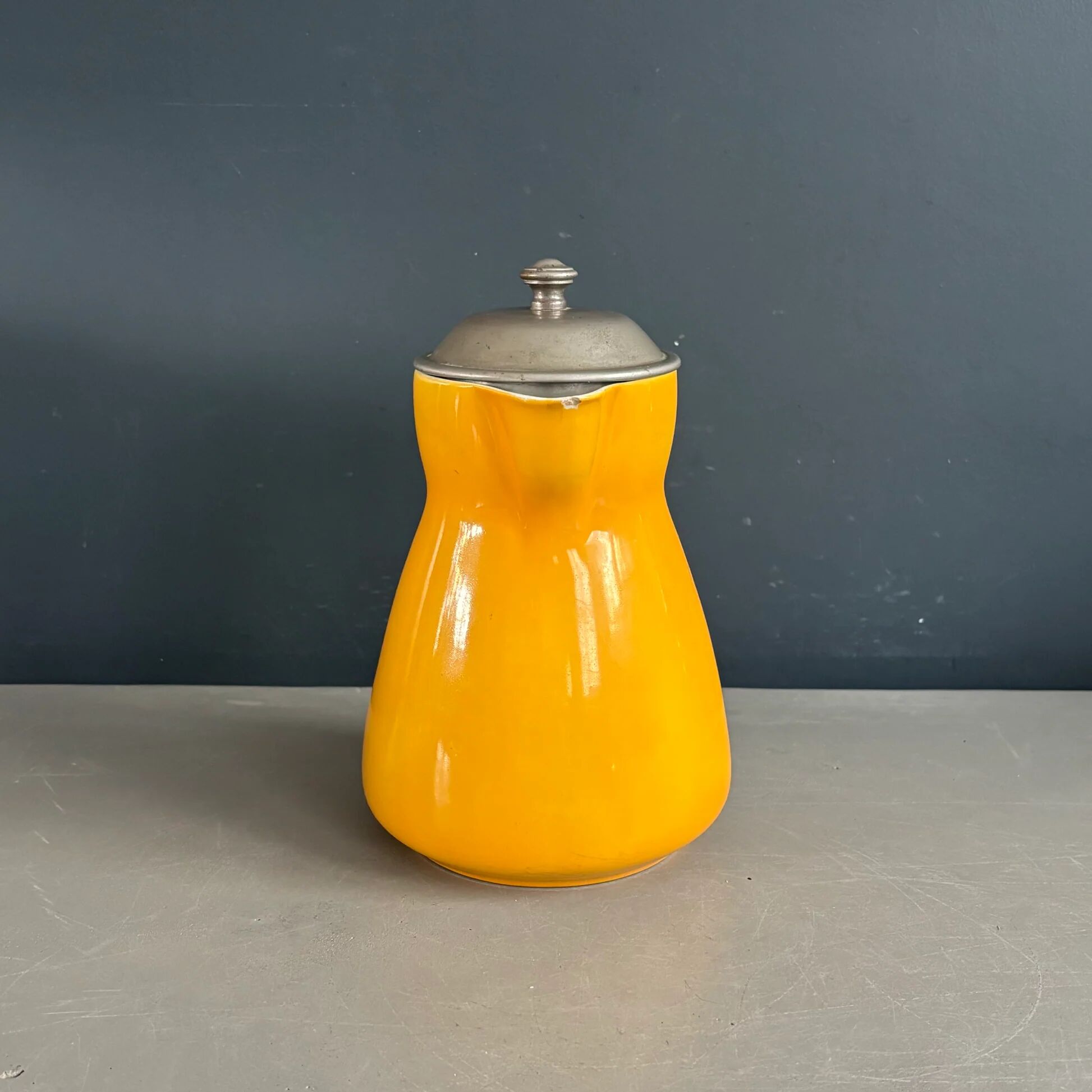 Antique teapot in earthenware with a tin filter lid.