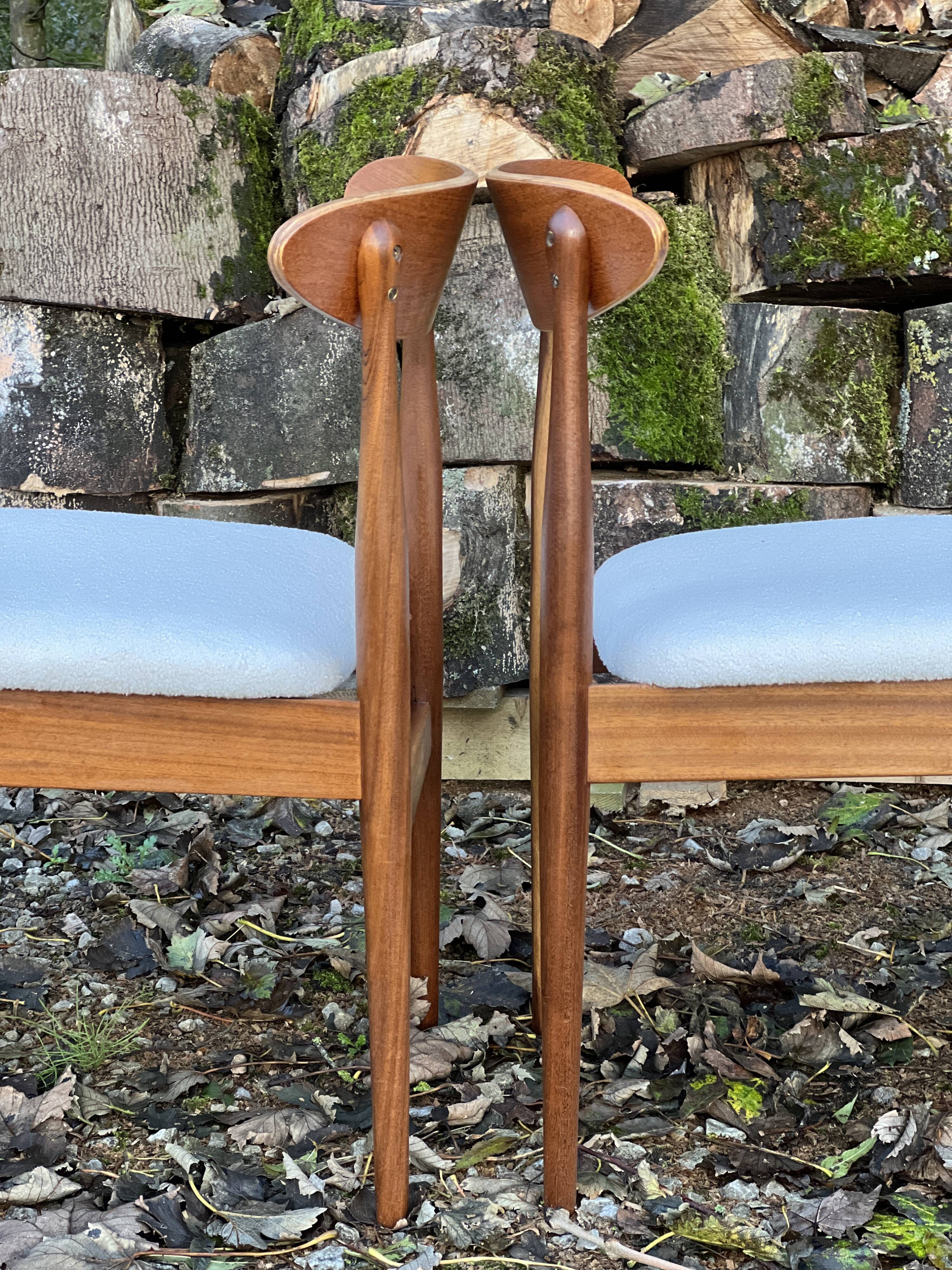 A set of GPlan chairs in teak with a white woolly fabric