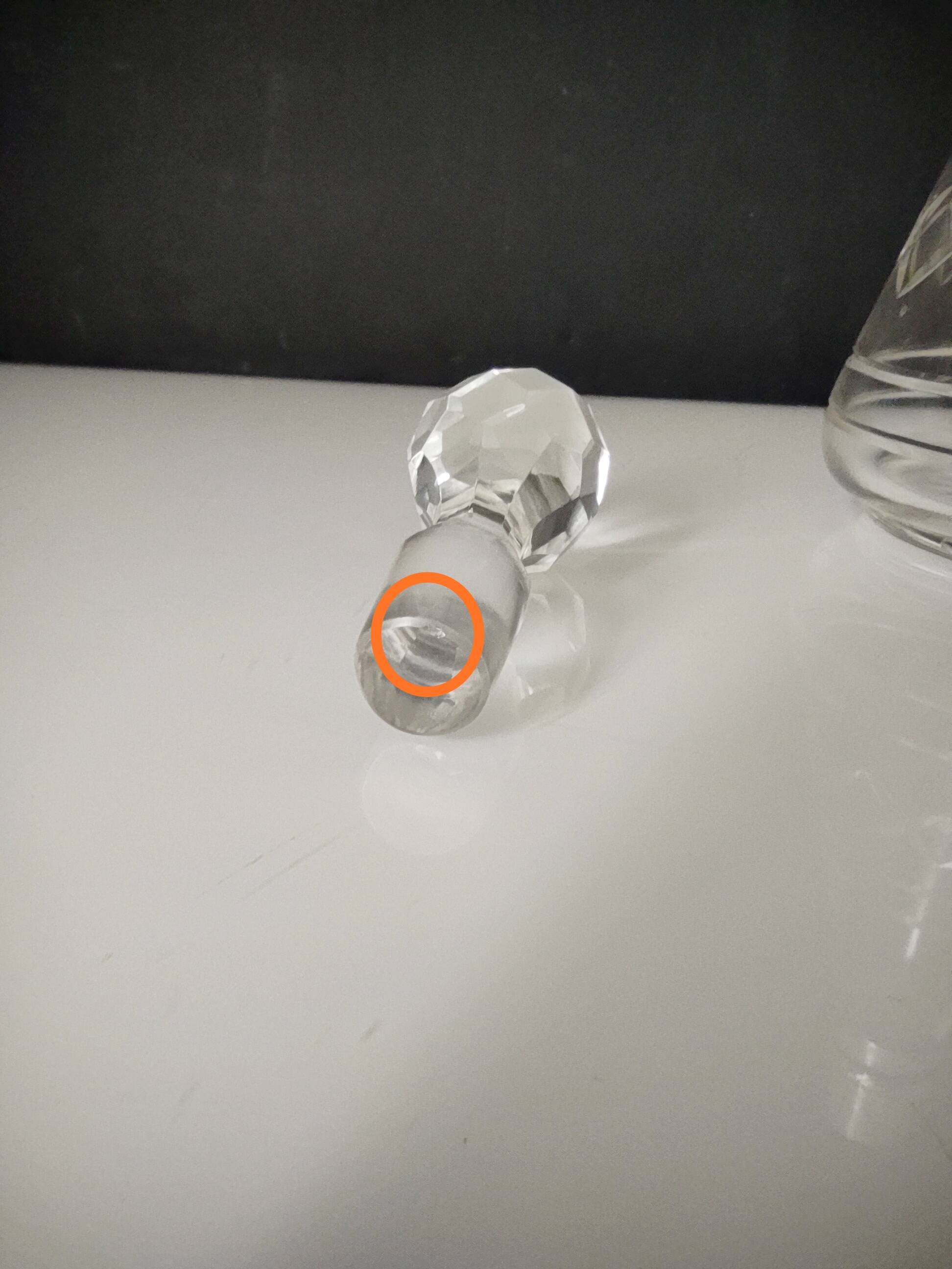 Crystal bottle with silver metal neck rim