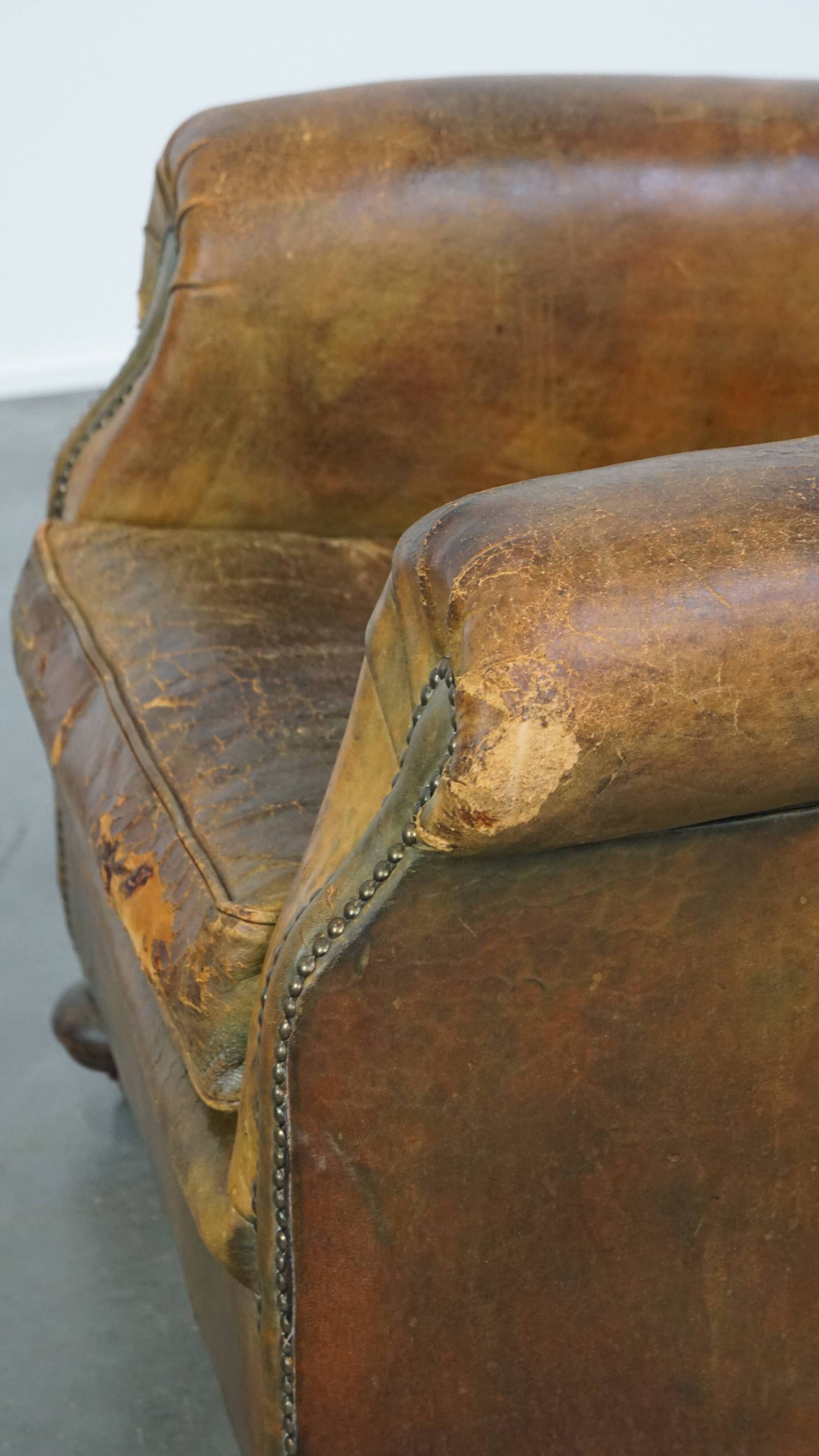 Green antique English cowhide leather armchair on wheels