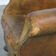 Green antique English cowhide leather armchair on wheels