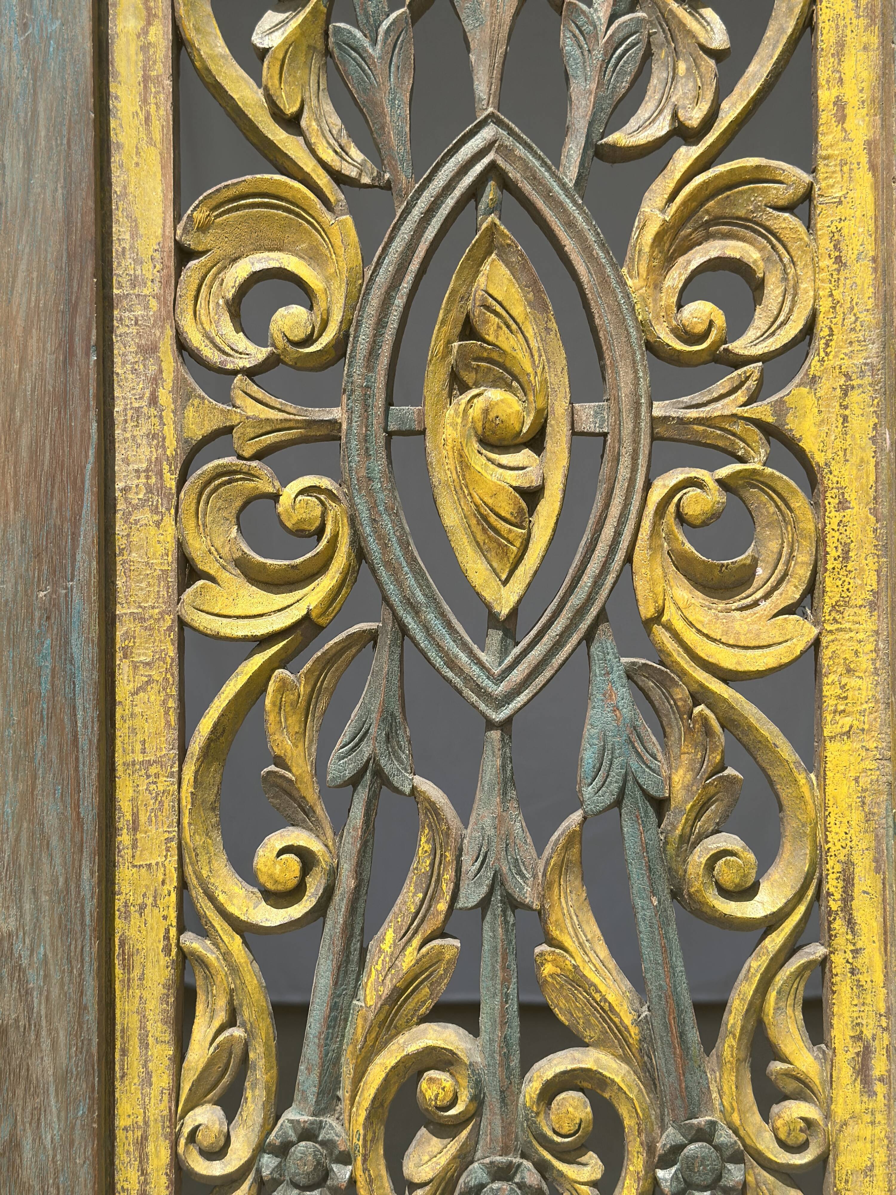 Rectangular Indonesian construction element with blue and yellow plant in carved wood