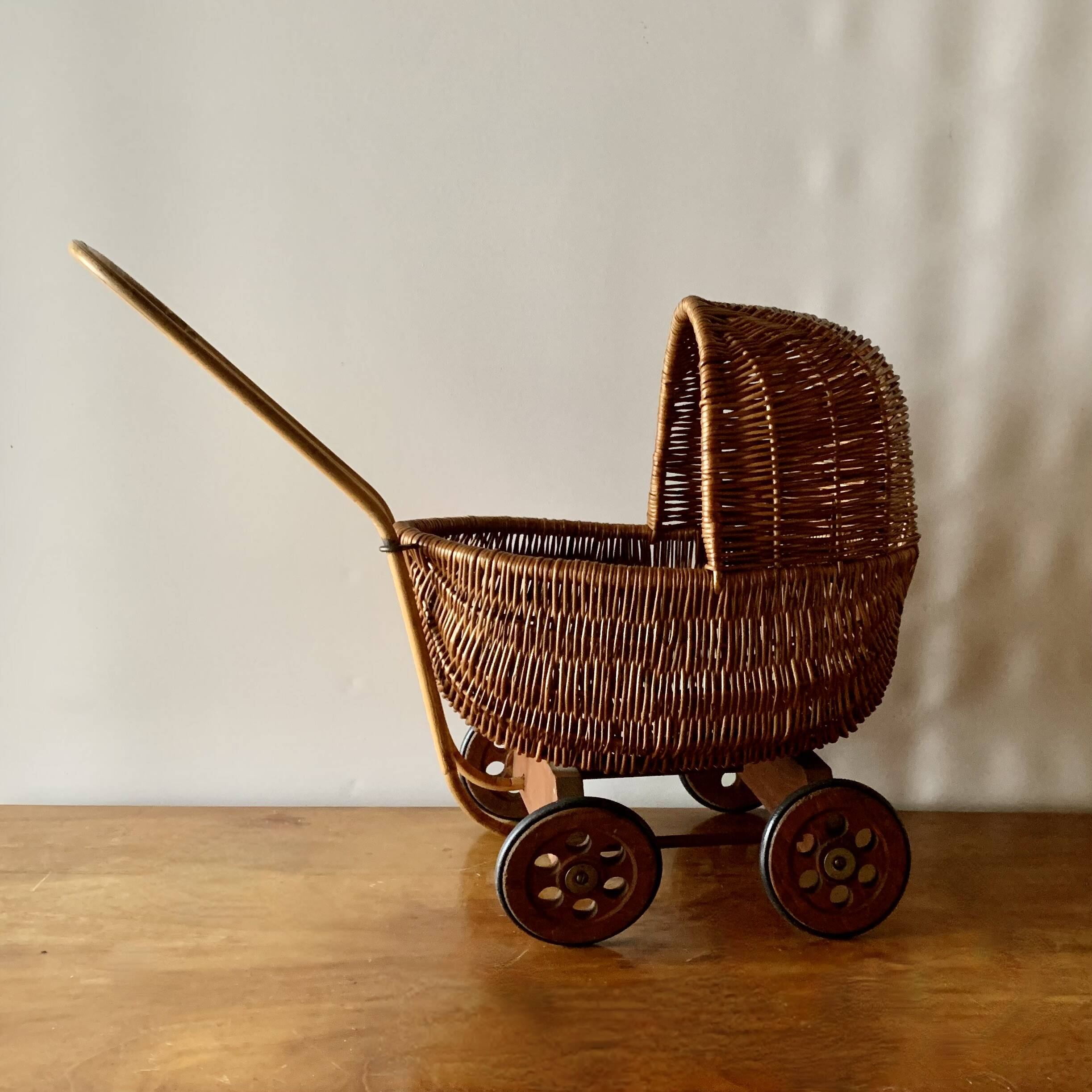 Old wicker dolls' pram - wooden wheels