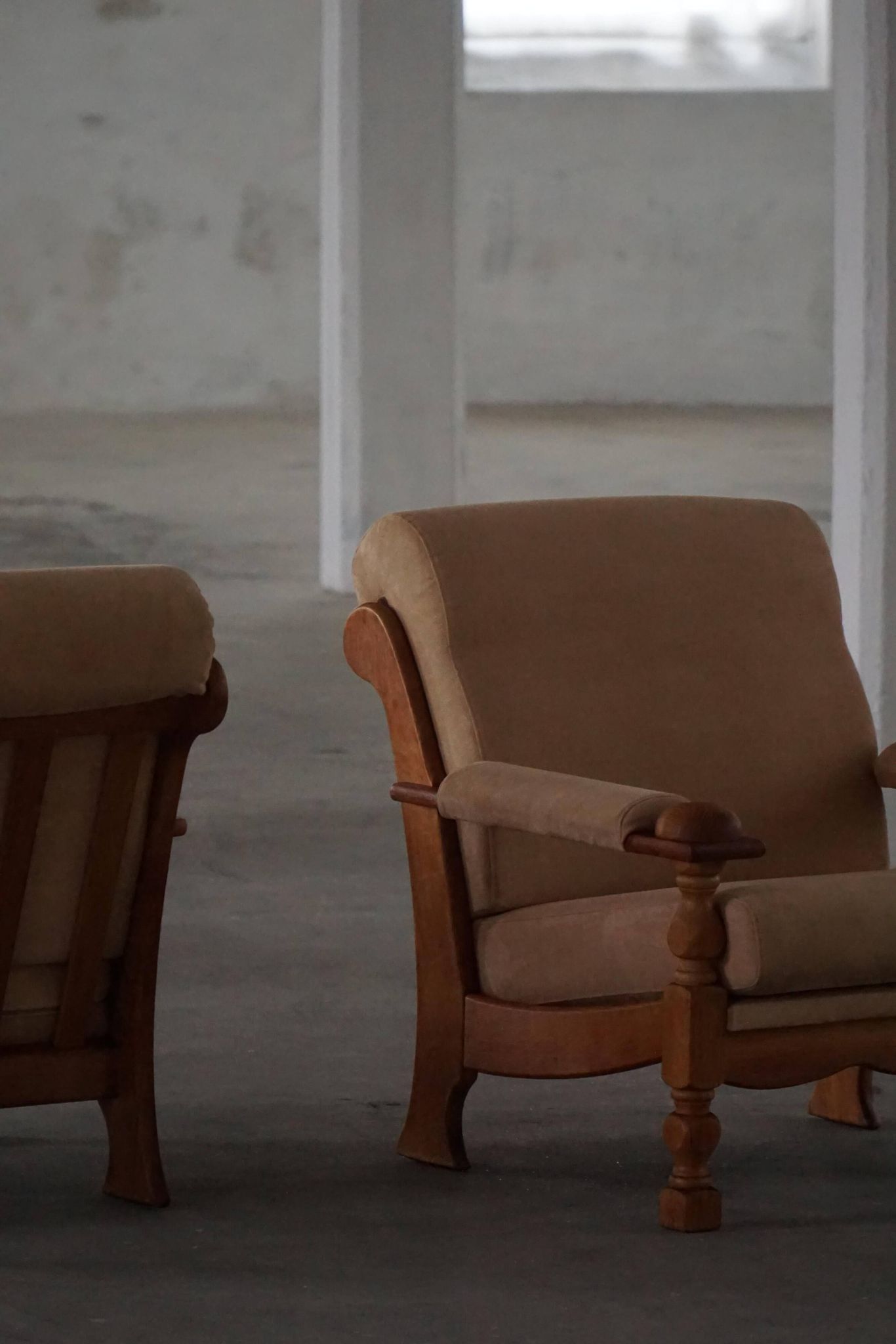 Mid-20th century, pair of armchairs by Henning Kjærnulf, oak and alcantara, 1960s.