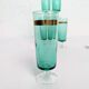 Set of 6 green champagne flutes with a golden rim.