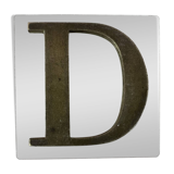 Metal letter D on glass plate