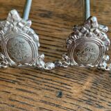 Series of 12 monogrammed silver metal knife holders