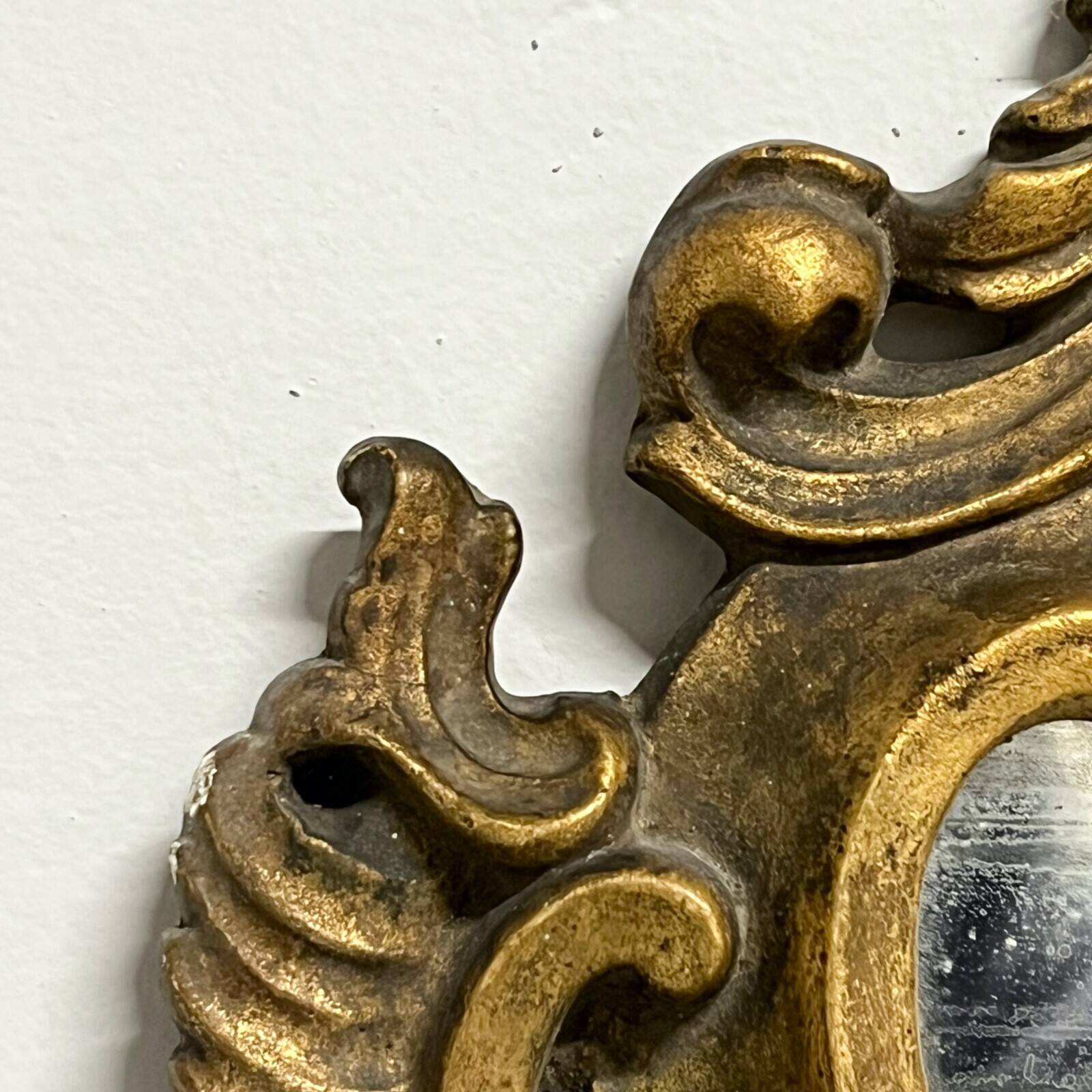 Pair of mirrors in wood decorated with gold leaf.