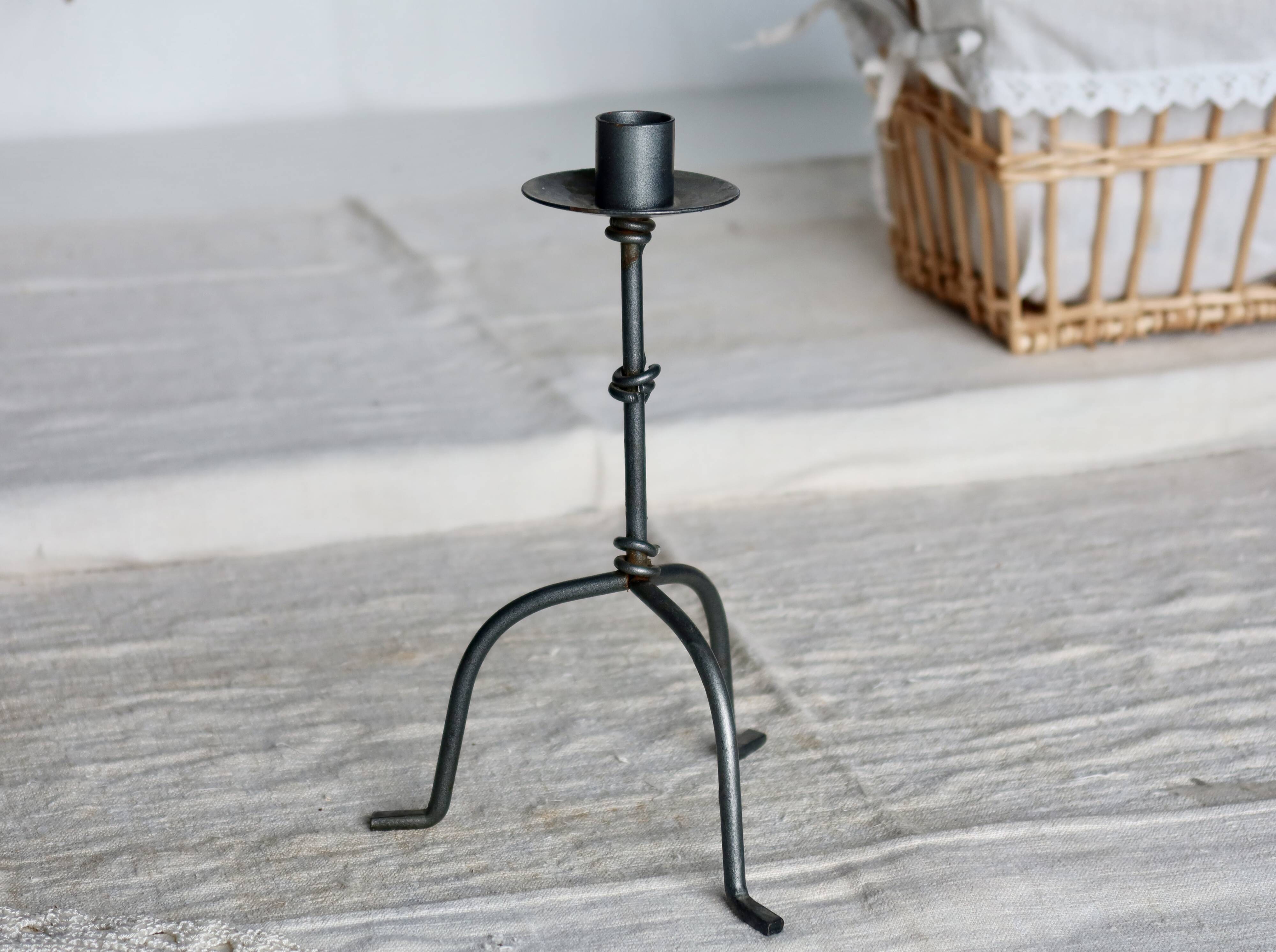 Antique tripod metal candlestick with knot decoration