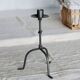Antique tripod metal candlestick with knot decoration