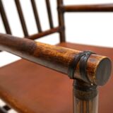 Manou rattan armchair with leather seat, 1960