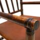 Fauteuil Manou en rotin et assise en cuir, 1960