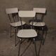 3 white Formica chairs