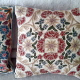 Set of three old hand-embroidered wool cushions
