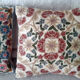 Set of three old hand-embroidered wool cushions