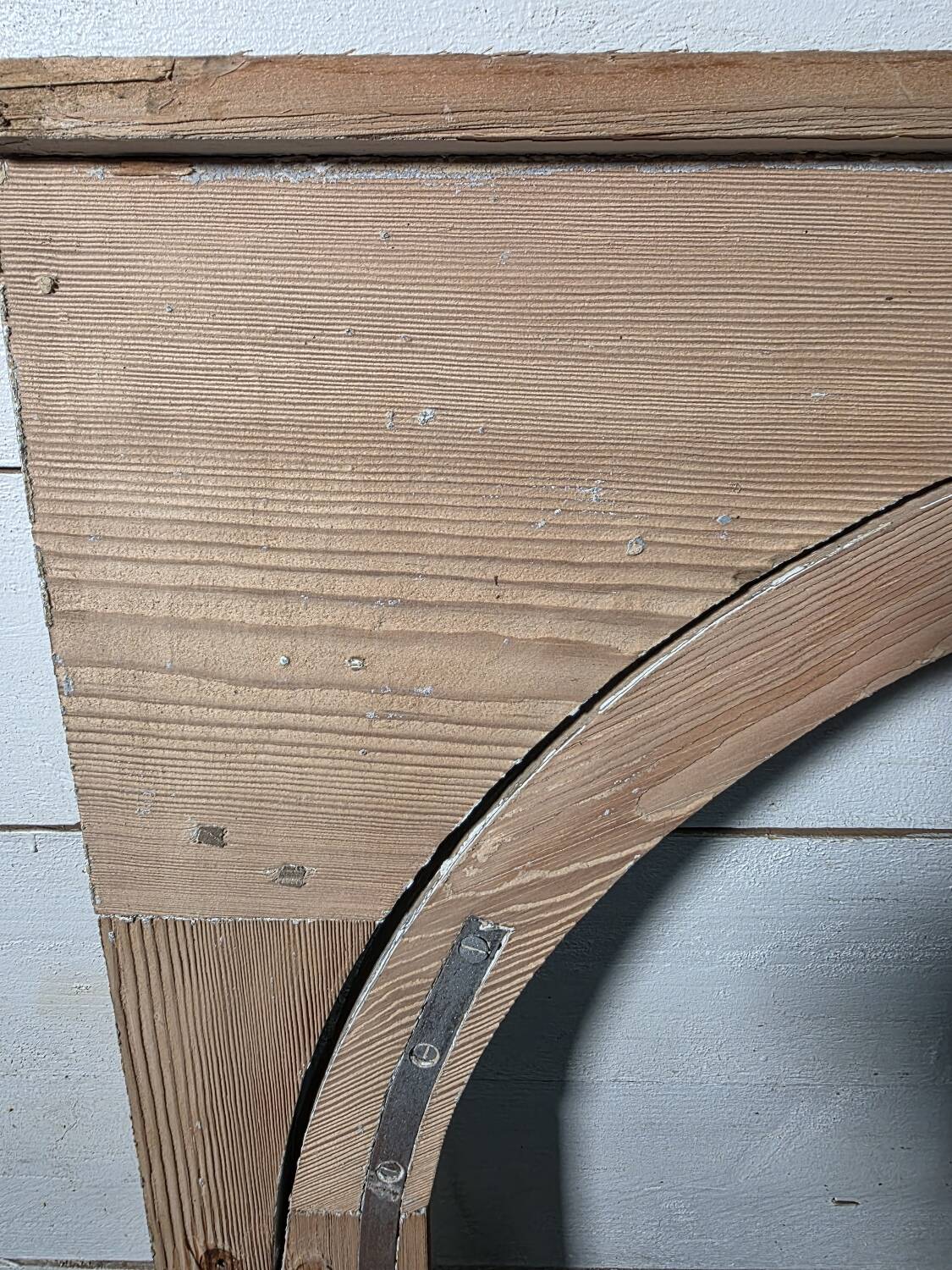 Old arched window made of fir wood