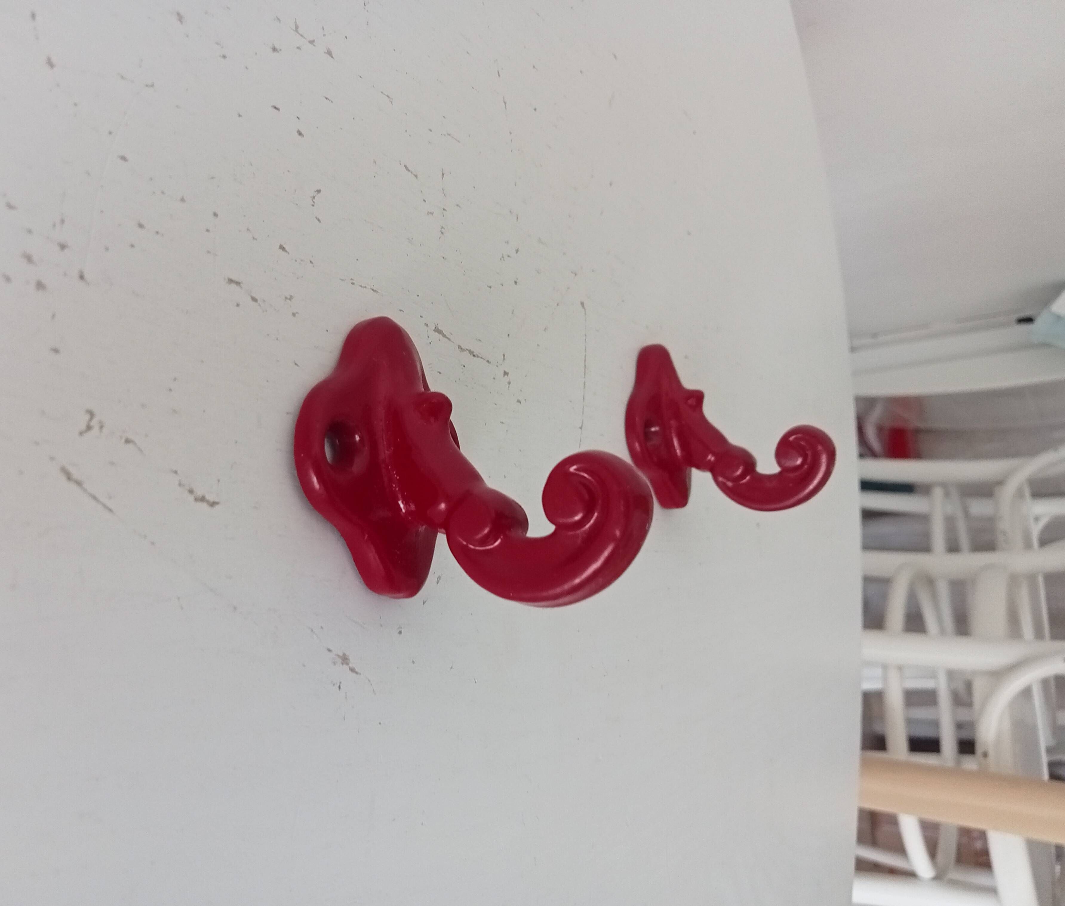 Pair of vintage wall hooks in enamelled cast iron.