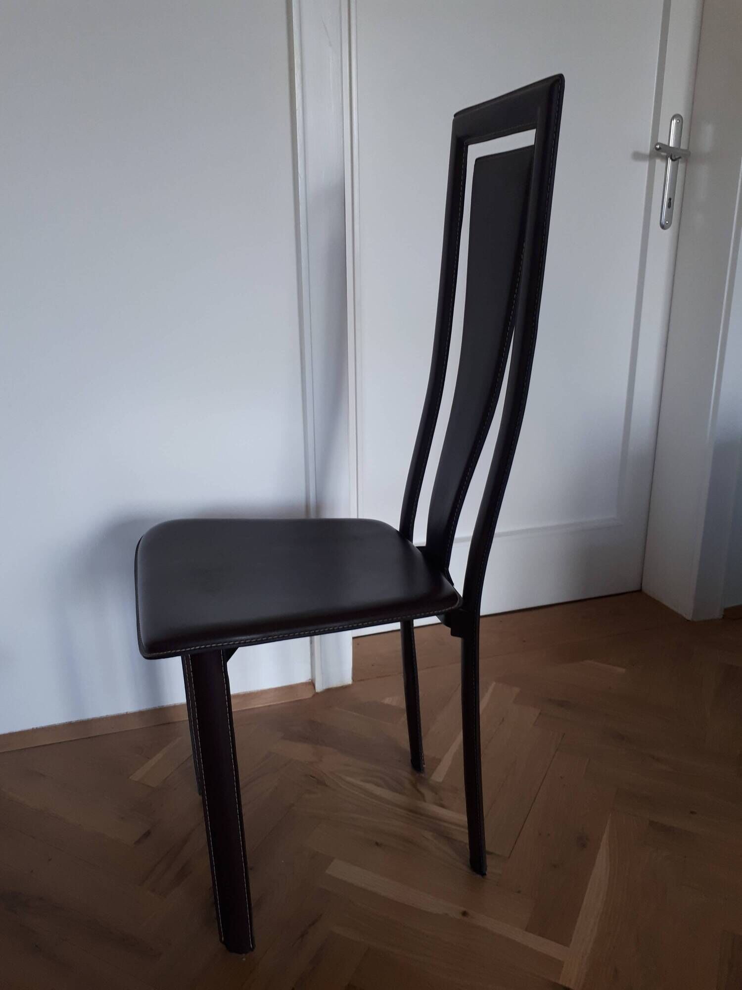 Set of 6 wooden chairs covered in leather.