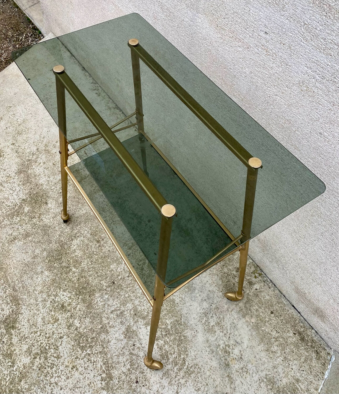 Vintage 1970s glass and gold rolling console table.