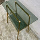 Vintage 1970s glass and gold rolling console table.