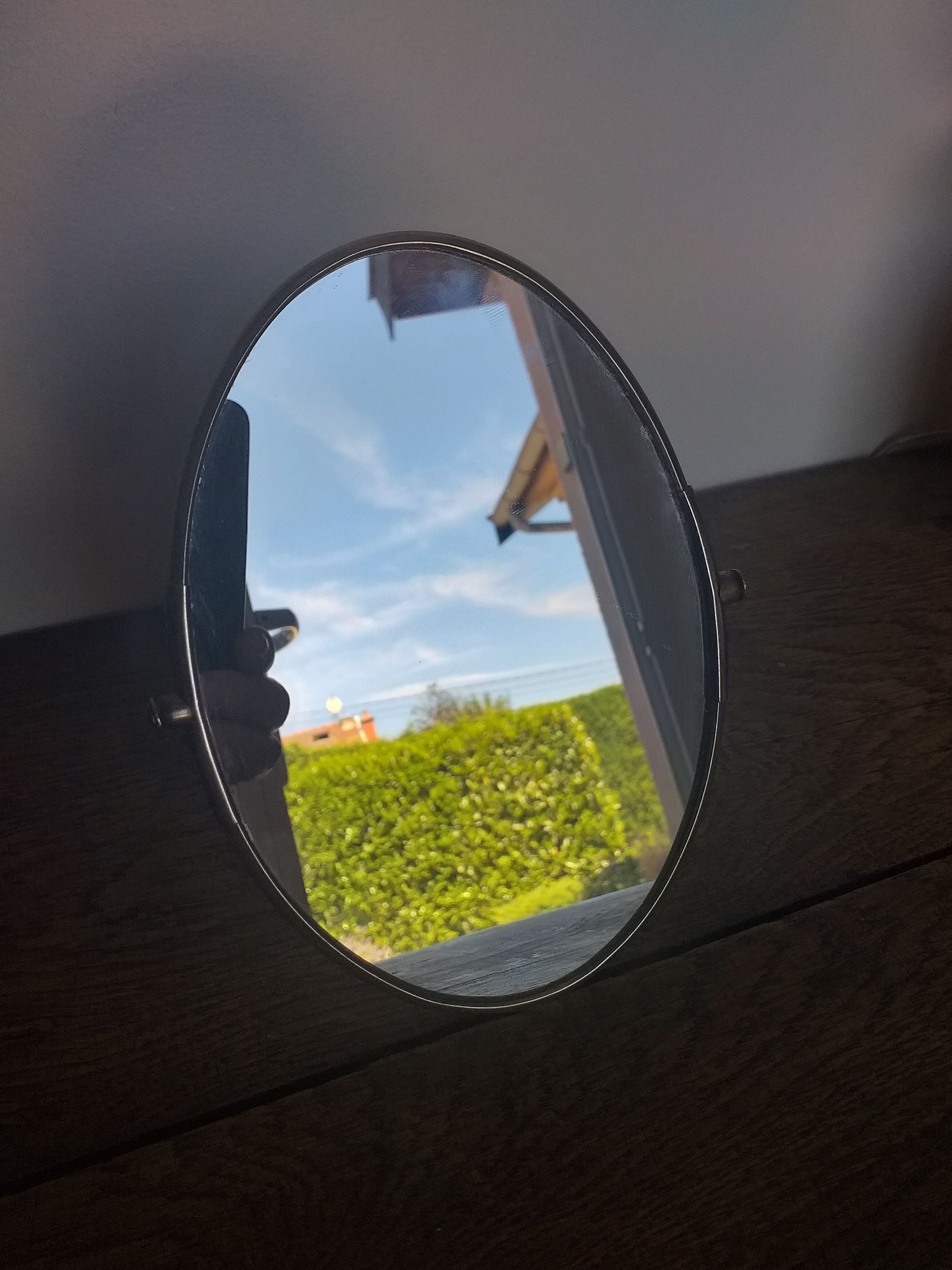 Vintage oval mirror on suspended stand