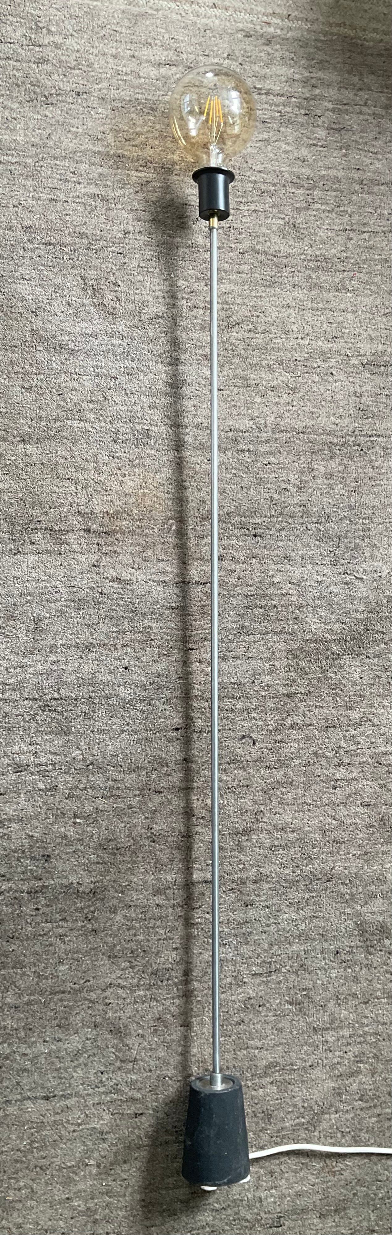Minimalist floor lamp in cast iron and chrome metal